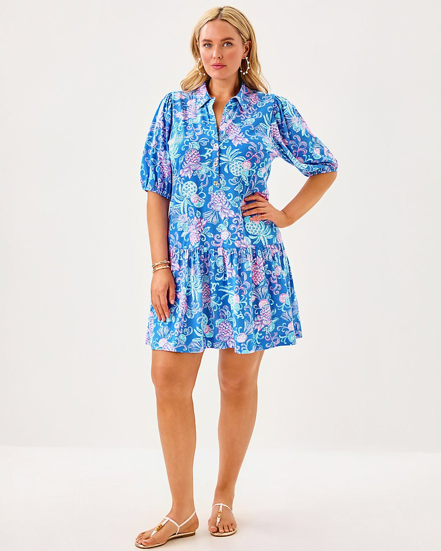 Woman wearing a blue floral dress on a white background